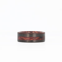 rosewood wedding ring with offset carbon fiber inlay laying flat