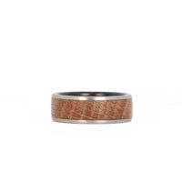 men's whiskey barrel wedding ring with titanium rails and forged carbon fiber sleeve laying flat