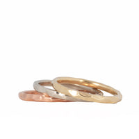 Gold hammered stackable rings laying down