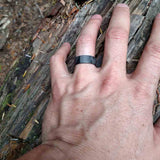 Carbon Ring Worn On A Hiker's Finger