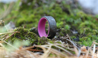 Purple Glow In The Dark Ring with Carbon Fiber outside in moss