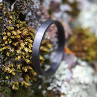 Carbon Fiber Stackable Ring on a log