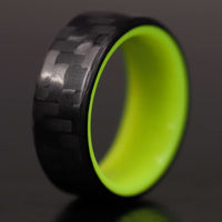 Yellow Glowing Resin Ring with Carbon Fiber close up on gray background