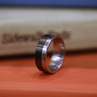 Men's Titanium Band with Carbon Fiber In Front Of Books