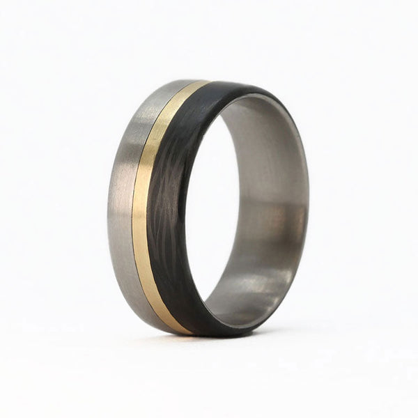 titanium ring with gold and carbon fiber inlays