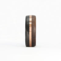 walnut wood and 14 karat rose gold wedding ring with carbon fiber sleeve front view