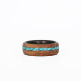 Turquoise Inlay Ring with Whiskey Barrel Wood and Carbon Fiber Sleeve Laying Flat