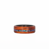 cocobolo wood ring with purple opal inlay and carbon fiber sleeve laying flat
